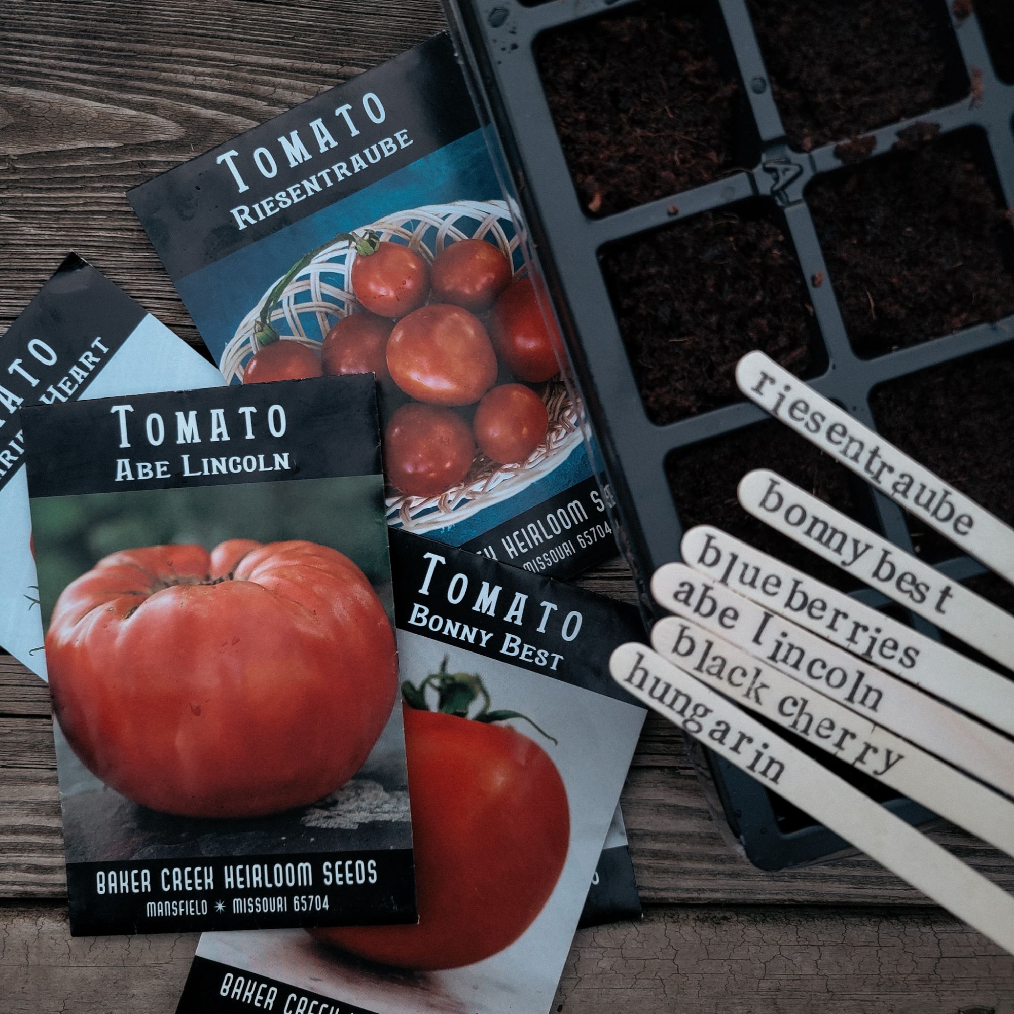 tomato seed packets, seed starting tray, and plant labels